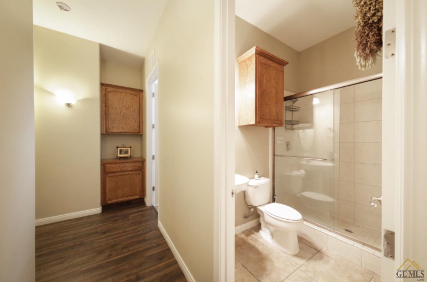 Undisclosed Address Bakersfield, CA 93314 - Photo 12 of 31 a bathroom with a toilet and a shower