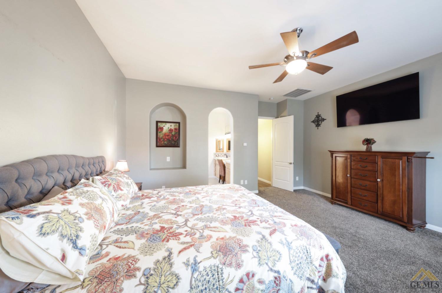 Undisclosed Address Bakersfield, CA 93314 - Photo 13 of 31 a bedroom with a large bed and a flat screen tv