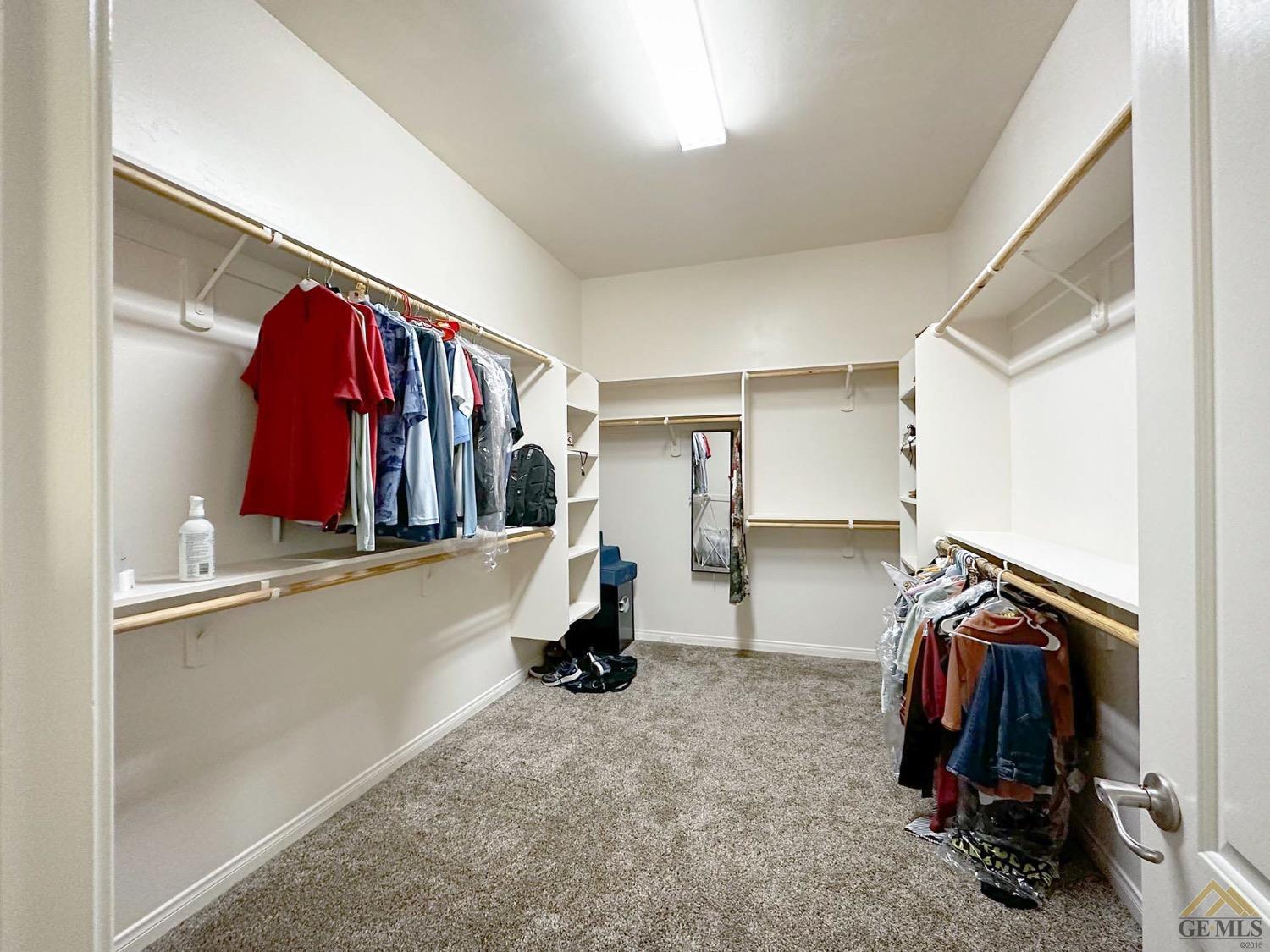 Undisclosed Address Bakersfield, CA 93314 - Photo 17 of 31 a view of walk in closet with clothes and shoes