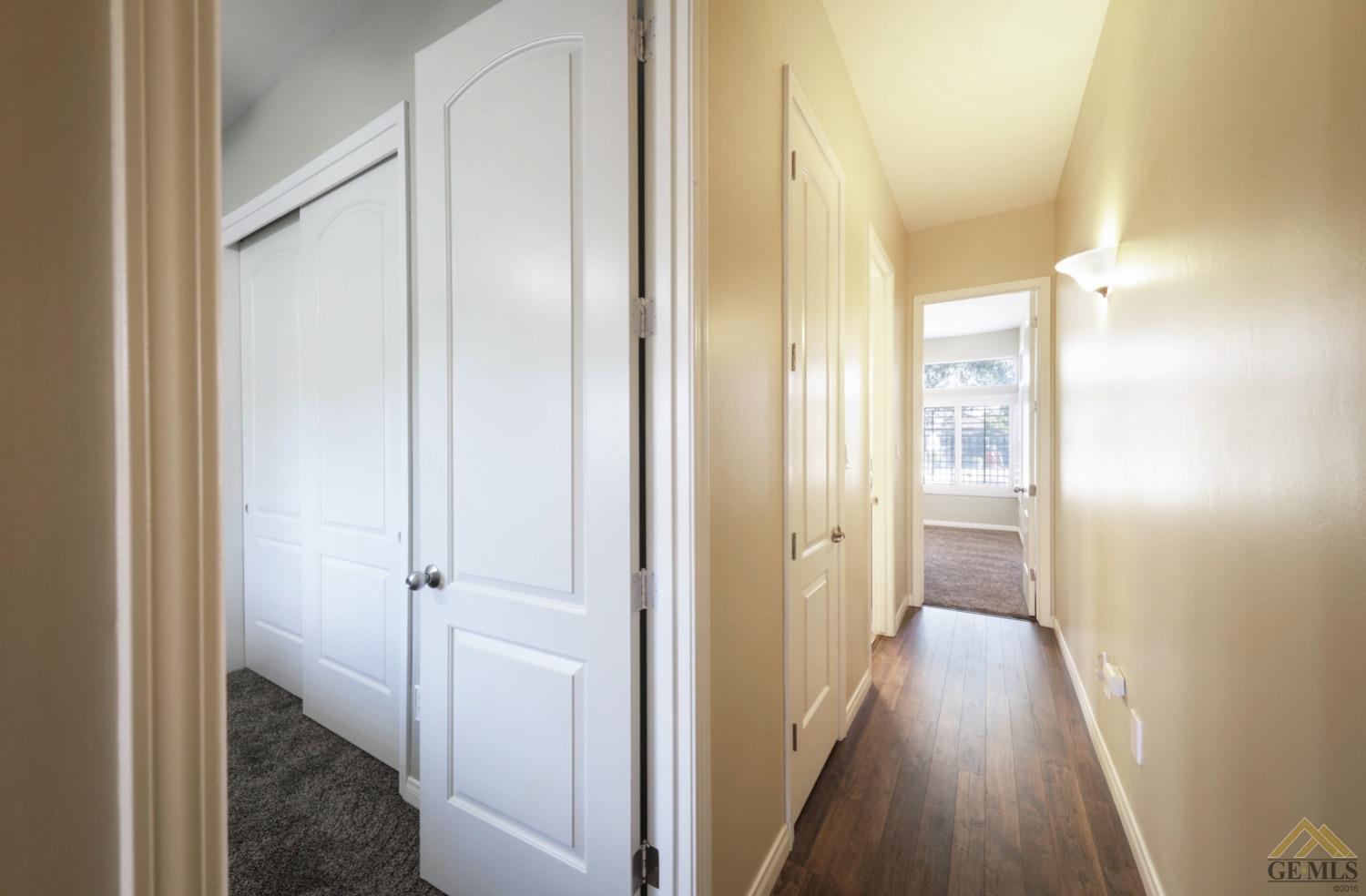 Undisclosed Address Bakersfield, CA 93314 - Photo 21 of 31 a view of a hallway with wooden floor