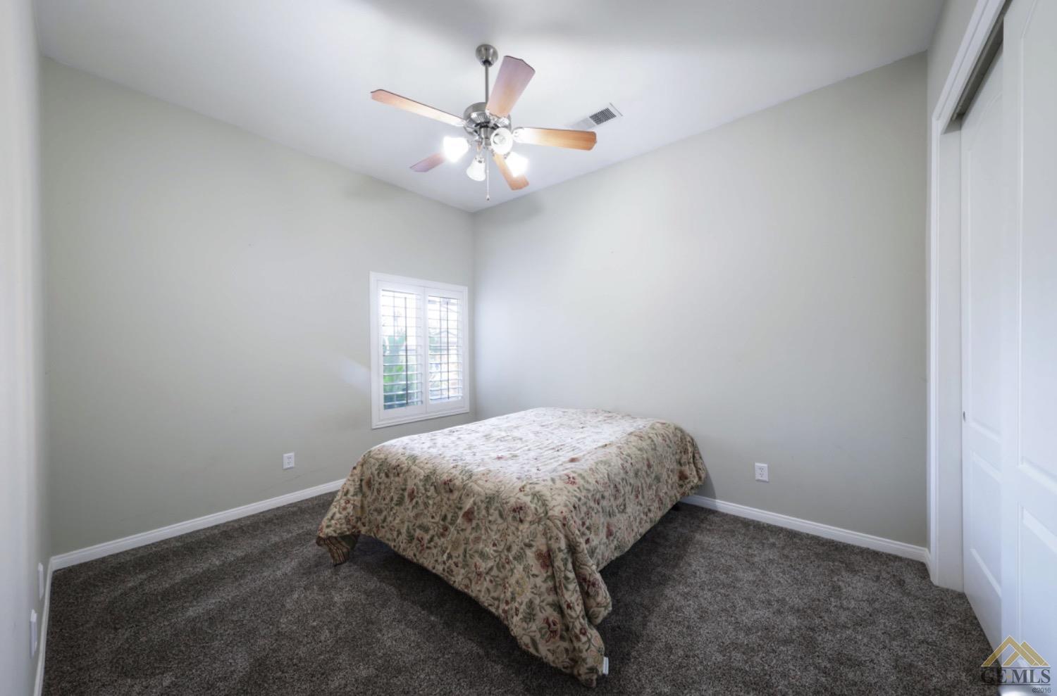 Undisclosed Address Bakersfield, CA 93314 - Photo 22 of 31 a bedroom with a bed and window