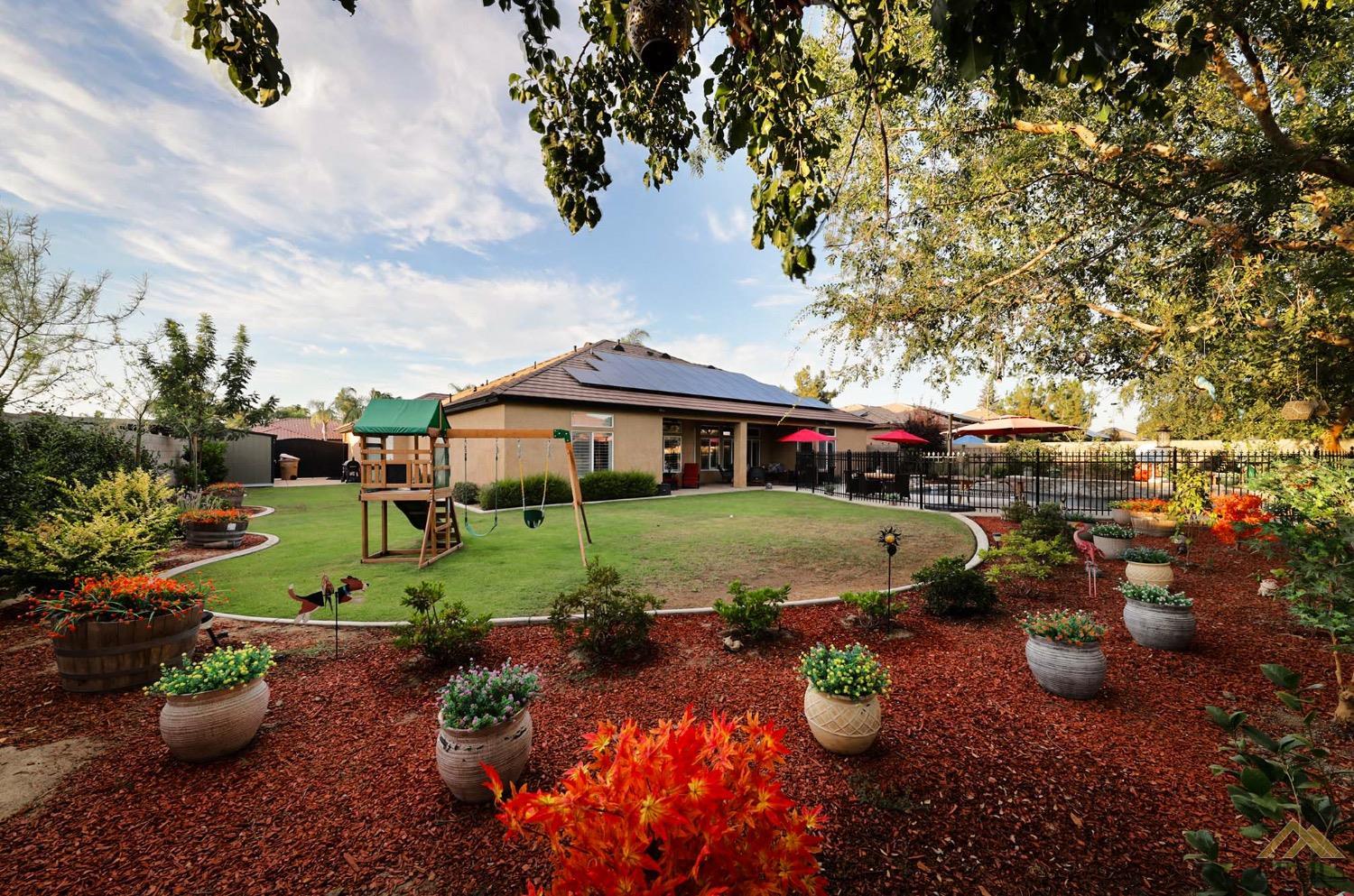 Undisclosed Address Bakersfield, CA 93314 - Photo 29 of 31 a view of a table and chairs in backyard