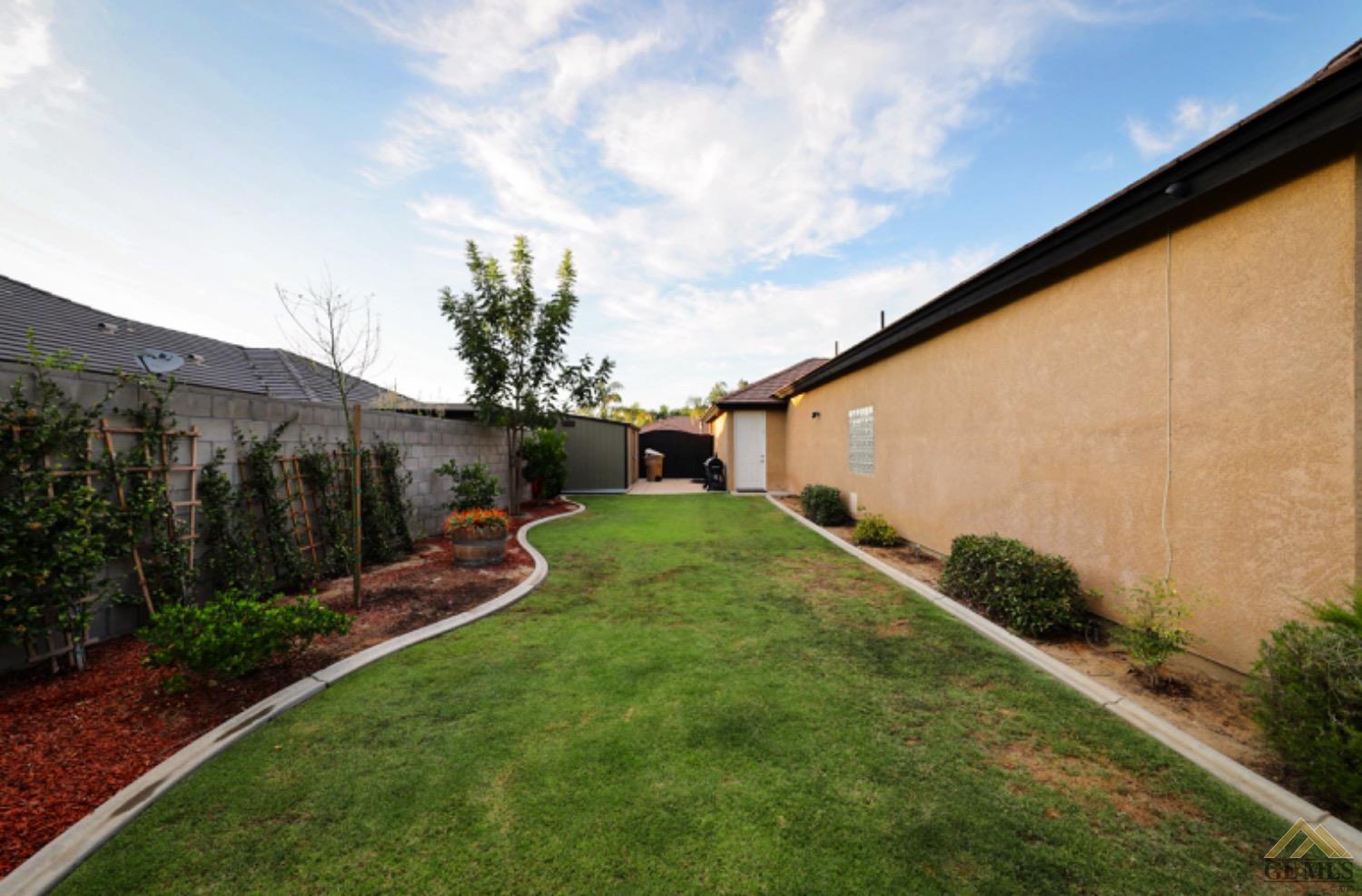 Undisclosed Address Bakersfield, CA 93314 - Photo 30 of 31 a backyard of a house with lots of green space