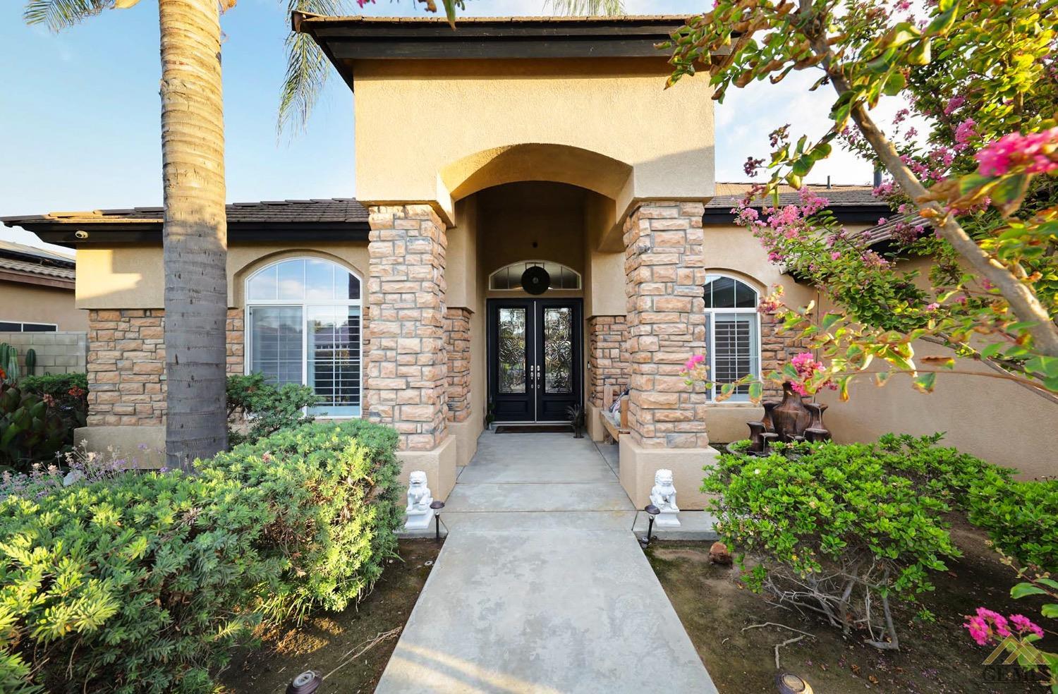 Undisclosed Address Bakersfield, CA 93314 - Photo 4 of 31 a front view of a house with a garden