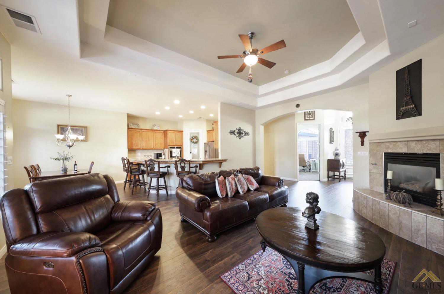 Undisclosed Address Bakersfield, CA 93314 - Photo 10 of 31 a living room with furniture a fireplace and a flat screen tv