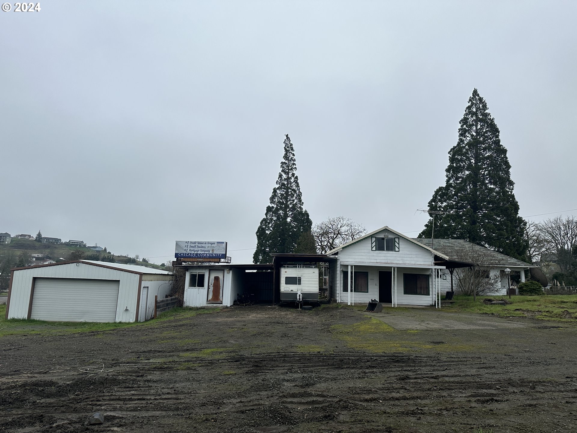 5114 Southwest Grange Road Roseburg, OR 97471 - Photo 4 of 11 a front view of a house with a garden