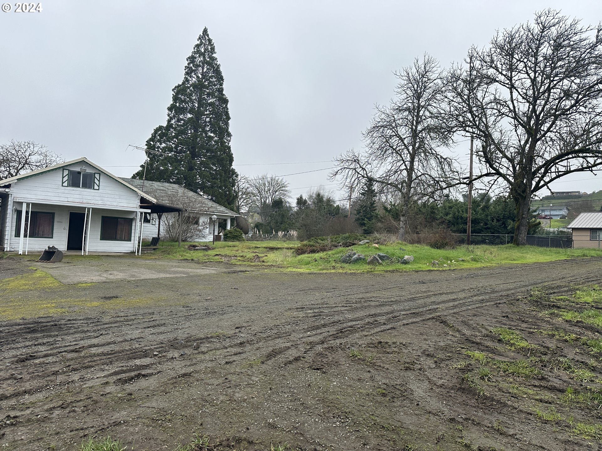 5114 Southwest Grange Road Roseburg, OR 97471 - Photo 5 of 11 a front view of a house with a yard