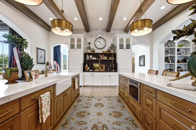 71 Farm Road Midway, UT 84049 - Photo 20 of 92 Gourmet kitchen with double islands, wood-finish flooring, exposed beam ceilings, and white countertops