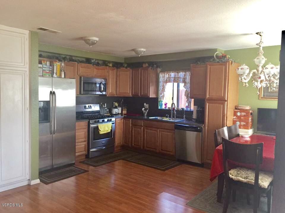310 Fairbourne Place Oxnard, CA 93033 - Photo 5 of 7 a kitchen with granite countertop a refrigerator stove top oven and sink