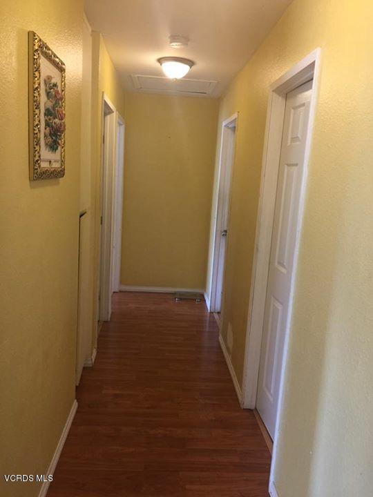 310 Fairbourne Place Oxnard, CA 93033 - Photo 6 of 7 a view of a hallway with wooden floor