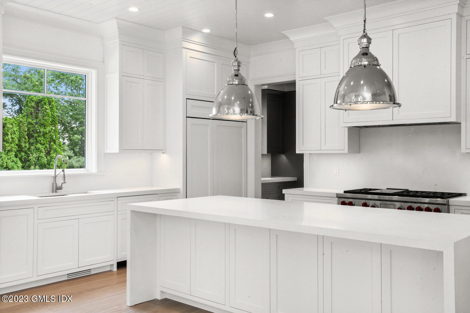 4 Ford Lane Old Greenwich, CT 06870 - Photo 12 of 43 a kitchen with stainless steel appliances a sink a stove a refrigerator and window