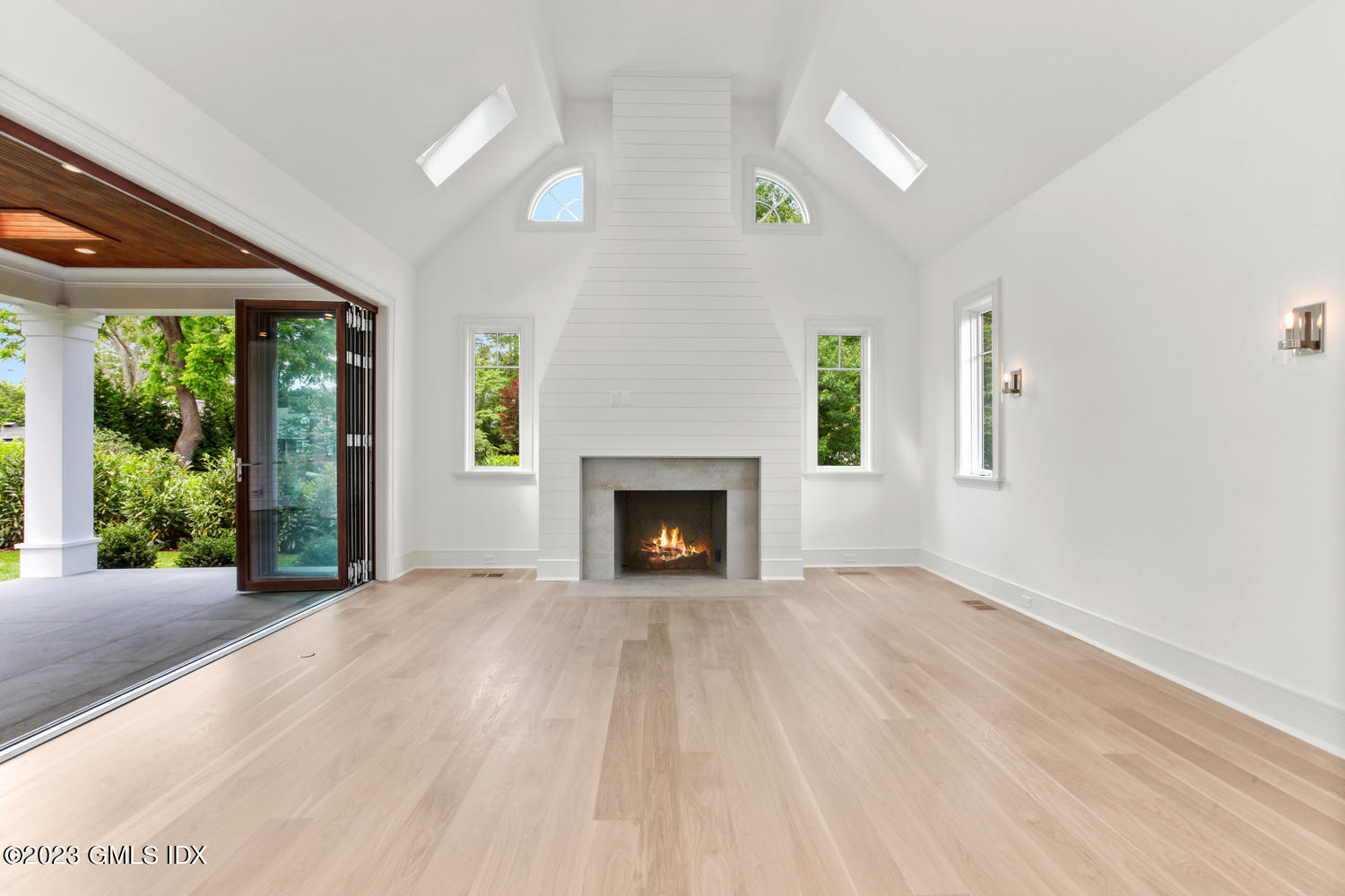 4 Ford Lane Old Greenwich, CT 06870 - Photo 14 of 43 a view of an empty room with a fireplace and a window