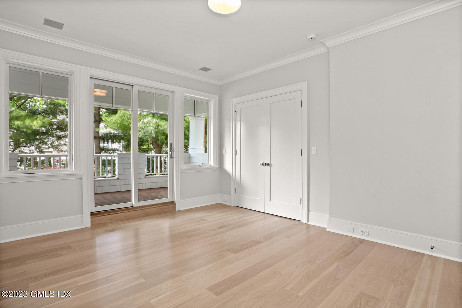 4 Ford Lane Old Greenwich, CT 06870 - Photo 18 of 43 an empty room with wooden floor and windows