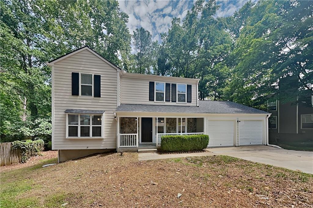 335 Olde Bridge Way Johns Creek, GA 30022 - Photo 1 of 19 a front view of a house with a garden