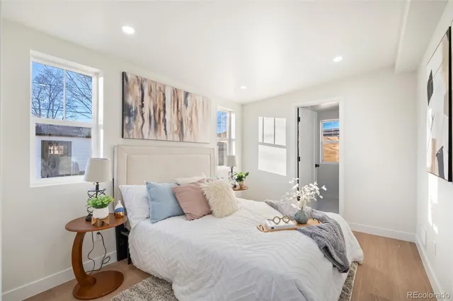 a bedroom with bed and wooden floor