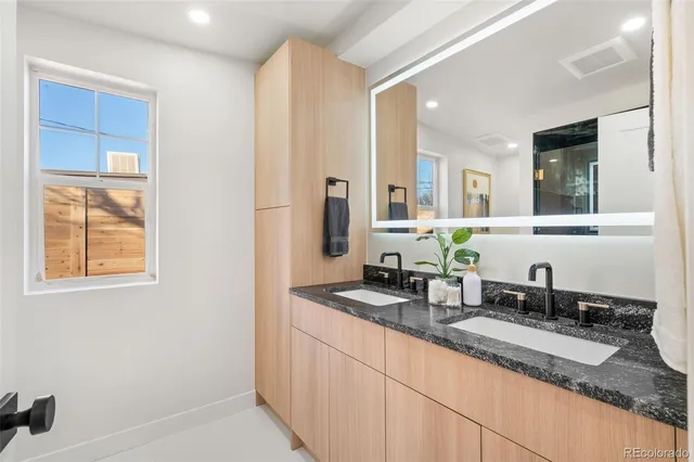a bathroom with a granite countertop sink and a mirror