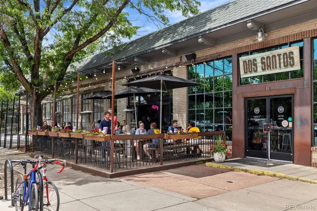 a view of group of people sitting in front of retail shop