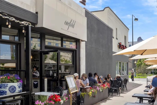 a group of people sitting in front of retail shop