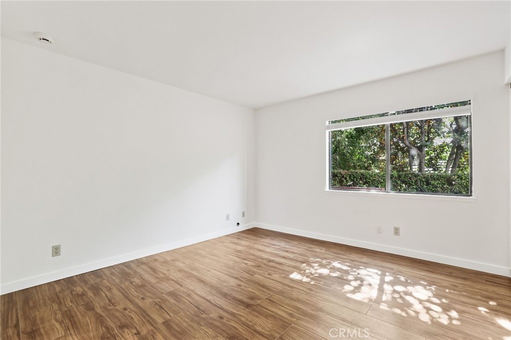 1862 Derby Drive North Tustin, CA 92705 - Photo 17 of 52 a view of an empty room with wooden floor and a window