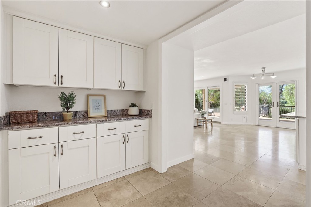1862 Derby Drive North Tustin, CA 92705 - Photo 19 of 52 a kitchen with granite countertop white cabinets white appliances and view living room