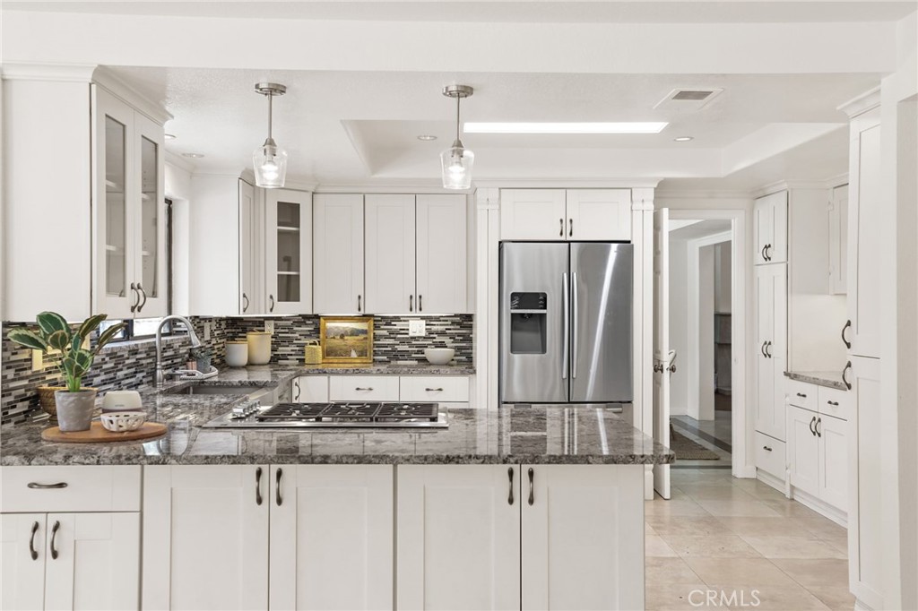 1862 Derby Drive North Tustin, CA 92705 - Photo 29 of 52 a kitchen with kitchen island granite countertop a refrigerator and a sink