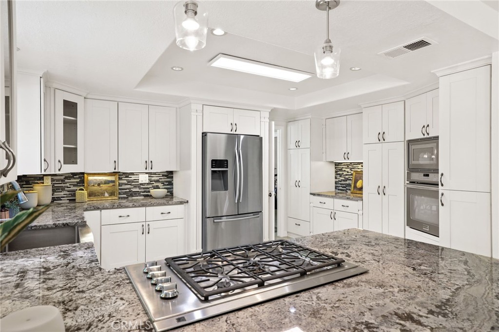 1862 Derby Drive North Tustin, CA 92705 - Photo 30 of 52 a kitchen with kitchen island a sink stainless steel appliances and a counter top space