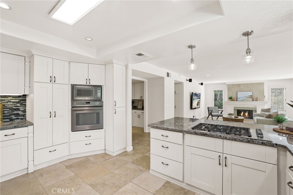 1862 Derby Drive North Tustin, CA 92705 - Photo 32 of 52 a kitchen with granite countertop white cabinets and stainless steel appliances