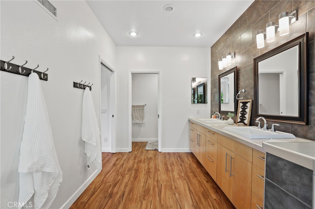 1862 Derby Drive North Tustin, CA 92705 - Photo 43 of 52 a spacious bathroom with a sink a large mirror and shower