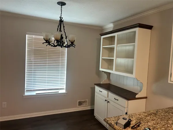 a room with chandelier and window