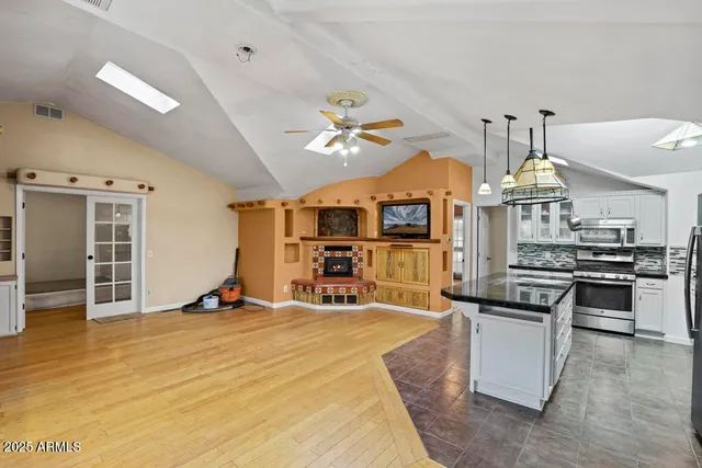 a view of a livingroom with furniture and a kitchen
