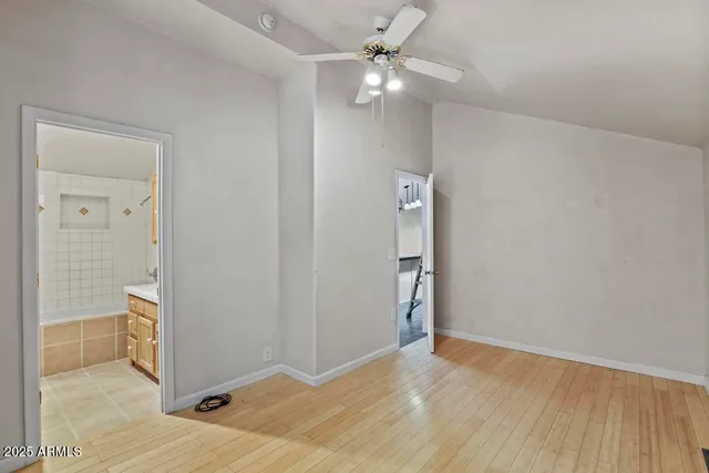wooden floor in an empty room with a bathroom