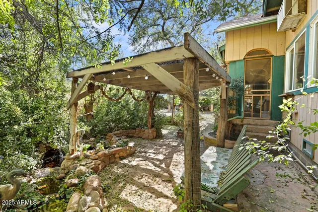 a yellow house with trees in front of it