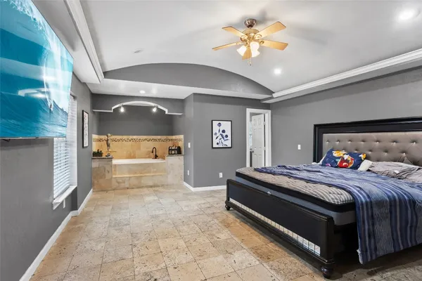 a bedroom with a bed and a chandelier