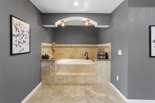 a view of a bathroom with a bathtub and shower