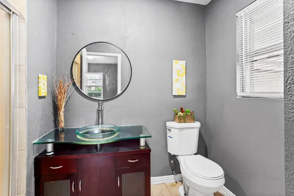 a bathroom with a toilet a sink and a mirror