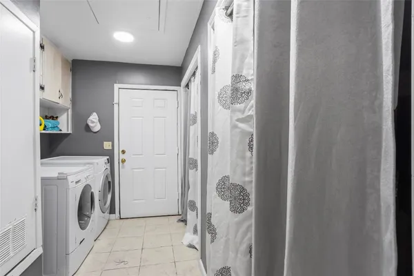 a view of a hallway with washer and dryer