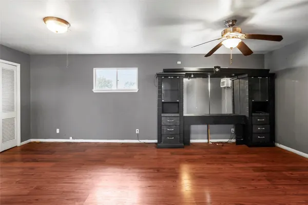 a view of empty room with wooden floor