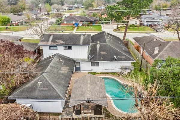 an aerial view of a house with a swimming pool