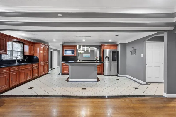 a kitchen with stainless steel appliances granite countertop a sink and a stove