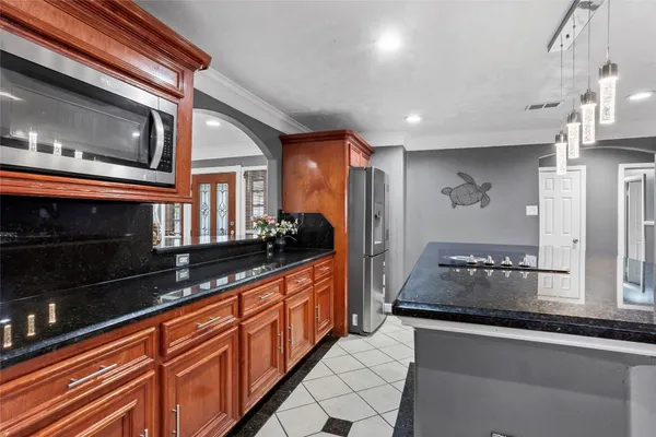 a kitchen with stainless steel appliances granite countertop a stove and a microwave
