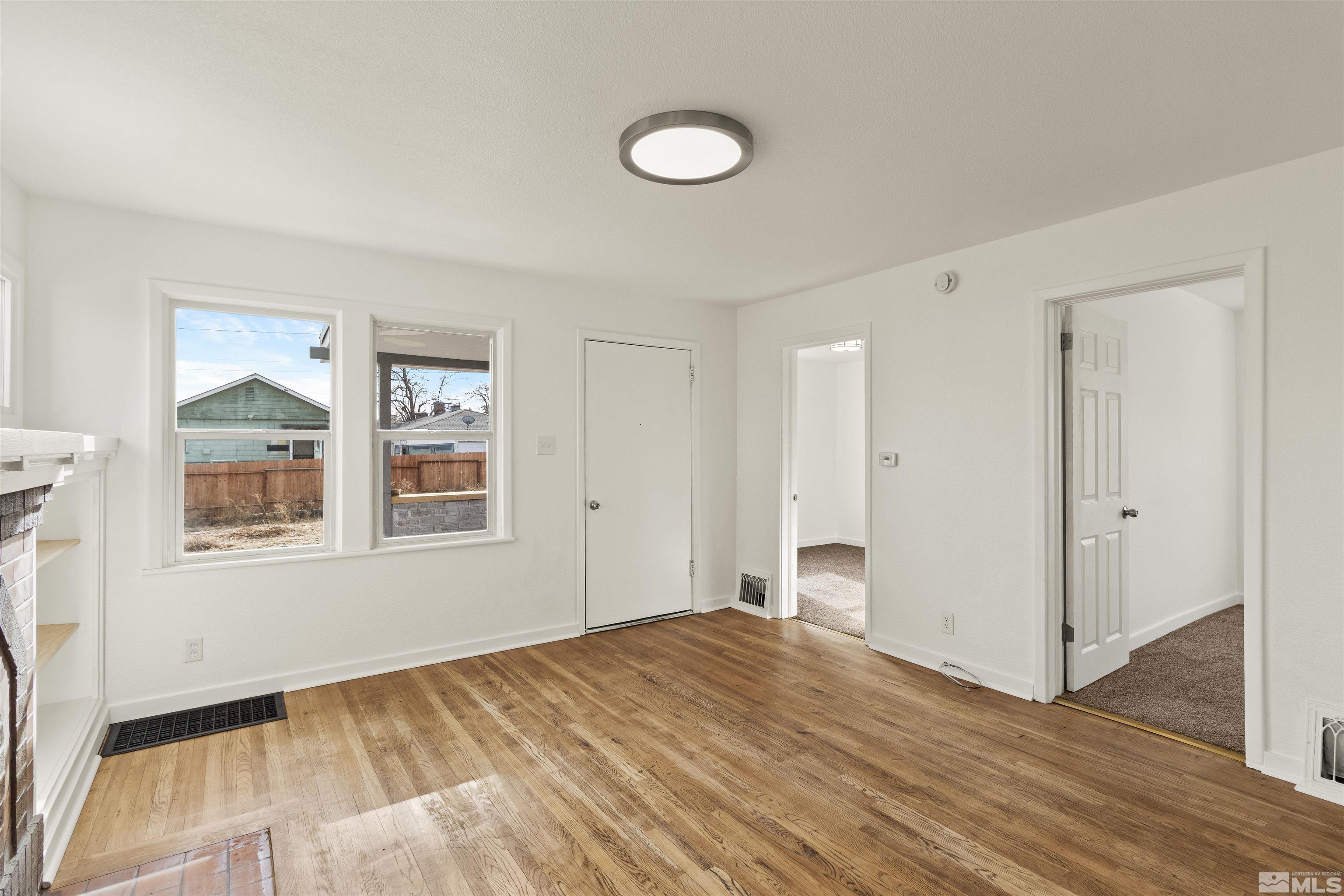 464 Cedar Street Reno, NV 89512 - Photo 8 of 40 a view of empty room with wooden floor and fan