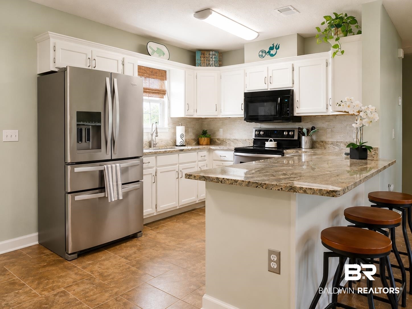 21733 Sedlack Road Silverhill, AL 36576 - Photo 12 of 22 Kitchen featuring white cabinetry, stone-finish countertops, and a full suite of stainless steel appliances