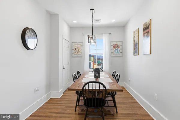 a view of a dining room with furniture wooden floor and chandelier