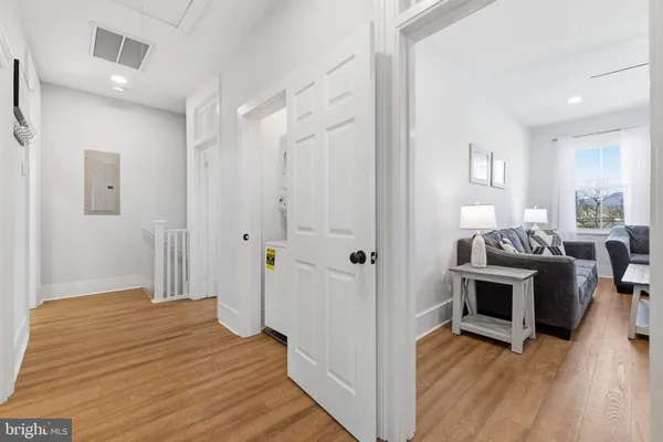 a view of washer and dryer with wooden floor