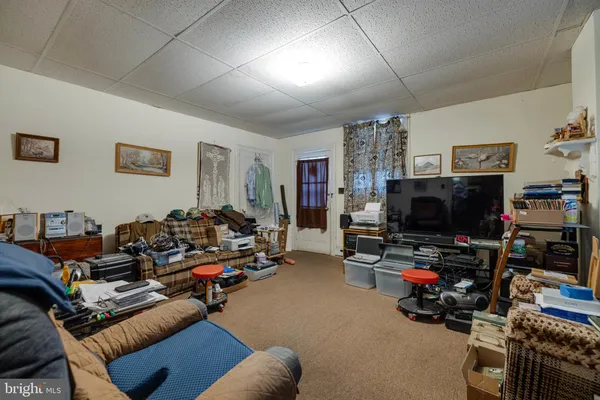 a play room with lots of furniture and a chandelier