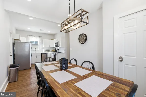 a view of a kitchen with a table and chairs