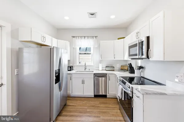 a kitchen with a refrigerator sink and microwave