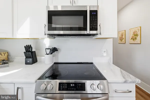 a open kitchen with white cabinets and appliances