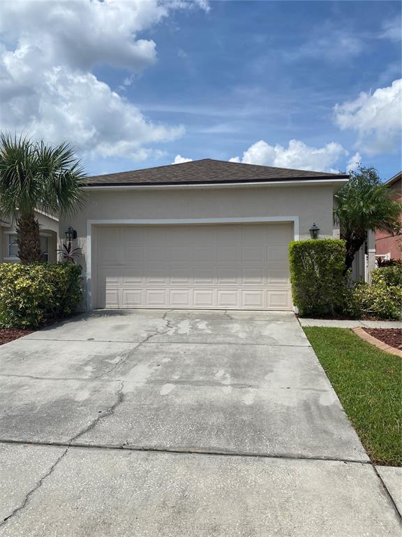 2409 Spring Hollow Loop Wesley Chapel, FL 33544 - Photo 1 of 47 a front view of a house with a yard and garage