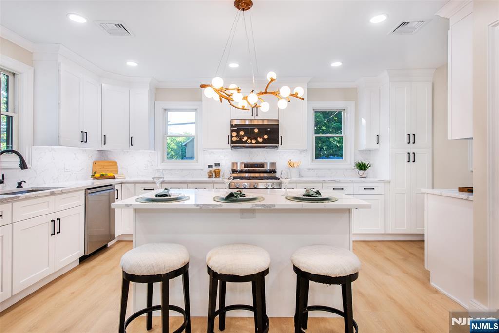 145 Grove Street Mahwah, NJ 07430 - Photo 8 of 30 a kitchen with a sink and chairs